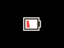 a black and white battery with a red arrow pointing to the left