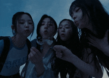 four girls are posing for a picture with one wearing a shirt that says " rt de vivre "