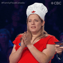 a woman wearing a chef 's hat with a maple leaf on it applauds