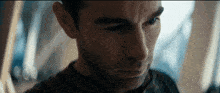a close up of a man 's face with a beard in a dark room .