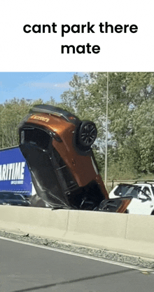 a car is upside down on the side of a highway next to a blue truck that says maritime