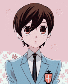 a boy in a suit and tie with a crest that says 4r