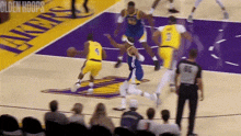 a group of basketball players are playing a game of basketball on a purple court .