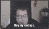 a man wearing glasses and headphones says " buy my mixtape "