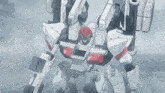 a white and red robot with a red head and a gun on its back