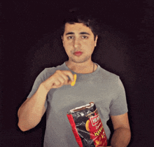 a man is holding a bag of hickory sticks