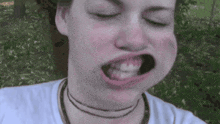 a close up of a woman making a face with her mouth open