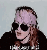 a man wearing sunglasses and a bandana is talking .