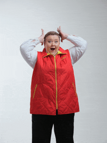 a woman wearing a red vest that says columbia