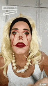 a woman is dressed as a clown and has a tiktok sticker on her face