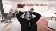 a woman is holding her head in front of a sign that says world record