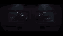a dark helmet with red eyes is visible through a window