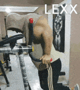 a man is doing dips in a gym and the name lexx is on the wall behind him