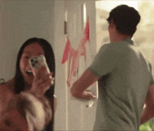 a man and a woman are standing in a doorway