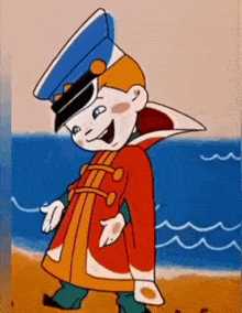 a cartoon character wearing a red coat and a blue hat is walking on the beach .