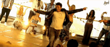 a group of people are dancing in front of a sign that says ' aamir '