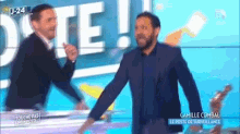 two men are standing in front of a sign that says date on it