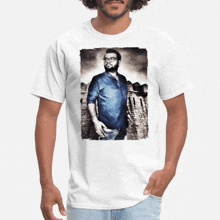 a man wearing a white t-shirt with a picture of a man with glasses on it