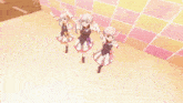 three anime girls are dancing in front of a wall