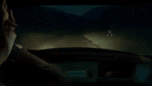 a pixelated image of a man looking out a window