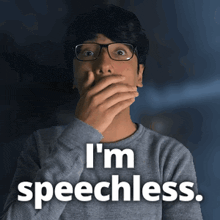 a man with glasses covering his mouth with his hand and the words i 'm speechless behind him