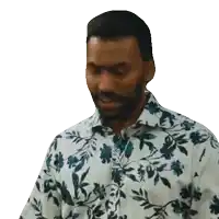 a man with a beard wearing a white shirt with blue flowers on it