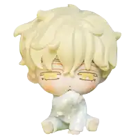 a figurine of a baby with yellow hair and white clothes