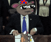 a man in a suit and tie with a cartoon mouse head