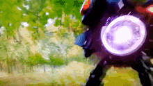 a blurry picture of a person riding a bike with a purple light