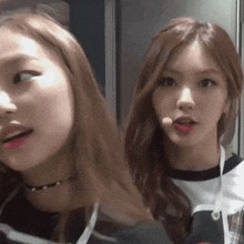 two girls are standing next to each other and one has a microphone in her hand