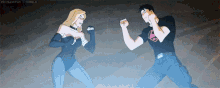 a man and a woman are standing next to each other and fighting .