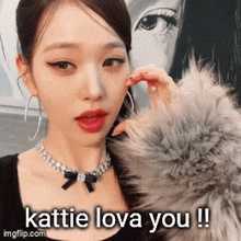 a woman wearing a fur coat and a necklace says katie love you !