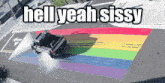 a rainbow painted on the side of a road with the words hell yeah sissy below it