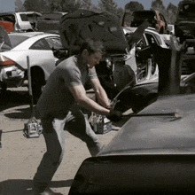a man is working on a car with its hood open