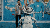 a group of people standing in front of a fantastic 4 poster