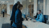 a man sitting at a desk with a sign that says bbc