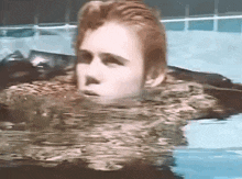 a person is swimming in a pool with their head in the water