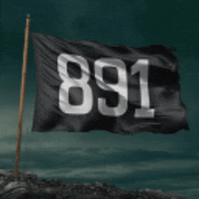a black flag with the number 891 on it is flying in the wind