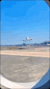 an airplane is taking off from a runway and looking out the window