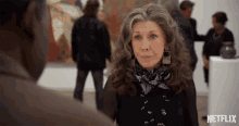 a woman stands in front of a man in a netflix ad