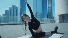 a woman stretching on a yoga mat with nike pro written on her shorts