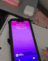 a cell phone with the time of 10:24 on it