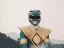 a green power ranger is standing with his arms in the air