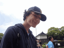 a young man wearing a blue hat with the letter a on it