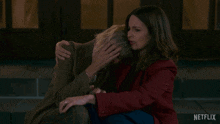 two women are hugging each other with a netflix logo in the corner
