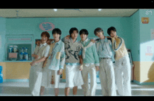 a group of young men are posing for a picture in front of a quality soda sign