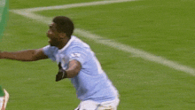 a soccer player is giving a thumbs up while on the field
