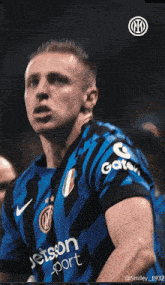 a soccer player wearing a blue and black jersey with jetson sport written on it