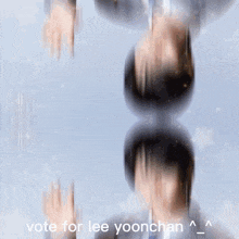 a blurry picture of a man in a suit and tie with the words vote for lee yoonchan