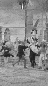 a group of people are dancing in front of a building